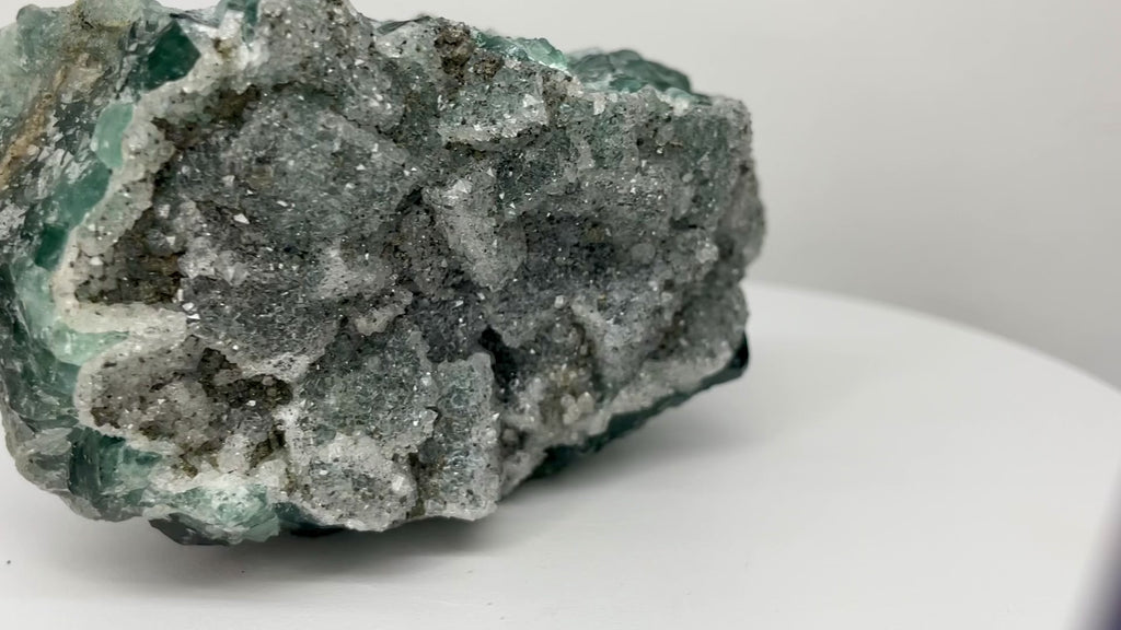 One-of-a-kind green fluorite with sparkling druzy from Nigeria featuring emerald-green crystal faces, natural white mineral vein, and UV-reactive crystals.